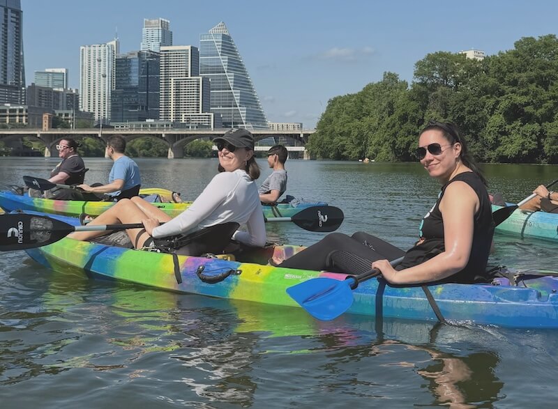 Photo of For People team kayaking at our annual in-person gathering