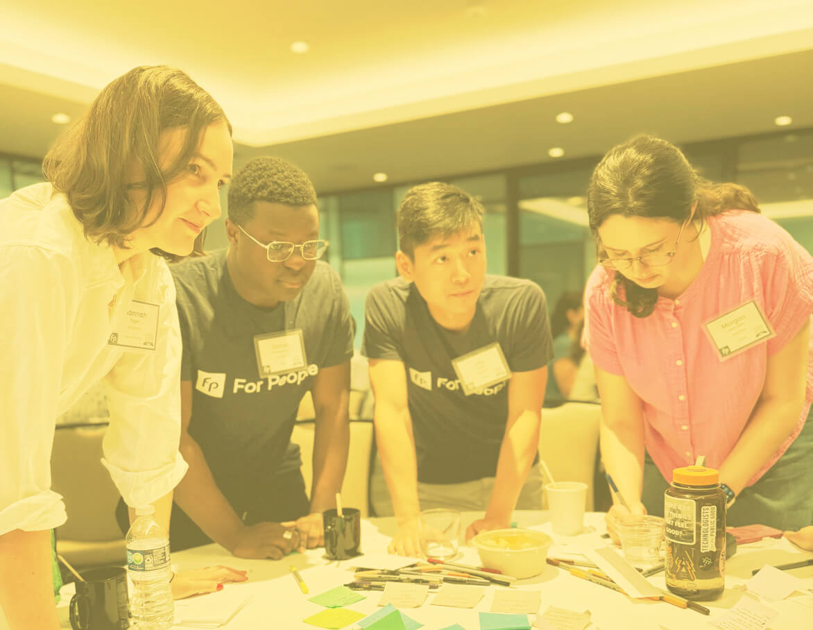 A team working at a table with index cards